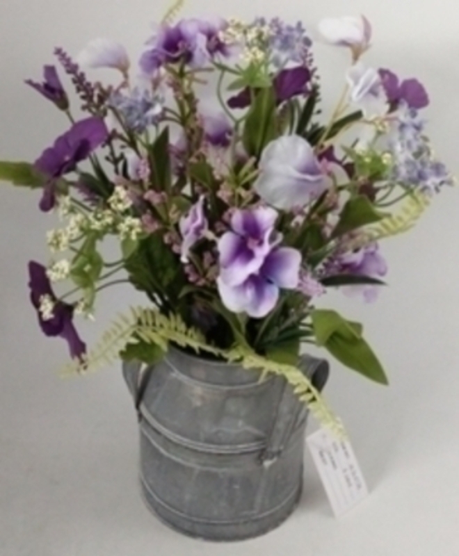 Lilac Meadow Flowers in Zinc Churn by Bloomsberry Lilac artificial meadow flowers by Bloomsbury. These stunning silk flowers come pre arranged in this lovely zinc churn and look hand picked from a meadow especially for you. For realistic artifical and silk flowers Bloomsbury is second to none.